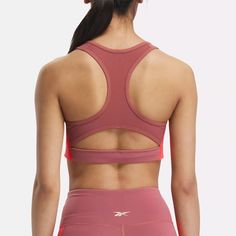 This Reebok sports bra offers medium support for spin class or personal training sessions. It has a pullover design, with removable pads for shaping and coverage. Angled side seams give you stability and support. When it's time to up the intensity, Speedwick tech helps wick sweat away from your skin. Pink Functional Sports Bra With Built-in Padding, Pink Athletic Fit Sports Bra, Sweat Resistant, Color Block Athleisure Sports Bra For Workout, Athleisure Color Block Sports Bra For Workout, Color Block Sports Bra Athleisure, Sporty Color Block Sports Bra For Workout, Athleisure Color Block Sports Bra, Pink Nylon Sports Bra For Light Exercise, Stretch Color Block Sports Bra For Training