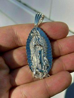 Gorgeous handmade Virgin Mary pendant
Will never turn green! SOLID 925 SILVER...Great investment!
1x2"Pendant weighs 9 grams!VERY DETAILED.Amazing handmade pieceYou can buy pendant alone or with choice of  2.5mm solid 925 silver chain.Chain is Made in Italy & comes in 18-30"If you look to buy only pendant it will fit most chains up to 5mm thick...would look really nice on a tennis chain too! Silver Our Lady Of Guadalupe Necklace, Spiritual Jewelry: Our Lady Of Guadalupe Round Pendant, Spiritual Silver Necklace With Our Lady Of Guadalupe, Silver Our Lady Of Guadalupe Pendant Jewelry, Mary Guadalupe, Guadalupe Necklace, Virgin Mary Pendant, 10k Gold Chain, Red Stone Ring