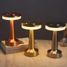 three different types of lamps sitting on top of a table