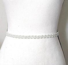 Enhance the elegance of your wedding gown with our exquisite pearl belt. Crafted with meticulous attention to detail, this beaded accessory adds a touch of sophistication to your bridal ensemble. Designed and handcrafted by ©JazzyAndGlitzy, it exudes charm and uniqueness, elevating your bridal look effortlessly. DETAILS: Handcrafted by ©JazzyAndGlitzy Features white pearls and ivory-toned ribbon Customizable lengths with ample ribbon on each side Welcome to custom orders and matching pieces HELP Belt For Wedding Dress, Wedding Dress Pearl, Beaded Bridal Sash, Accessories For Bride, Belt Wedding Dress, Wedding Accessories For Bride, Pearl Belt, Wedding Belt, Corsage Prom