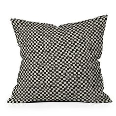 a black and white checkered pillow on a white background