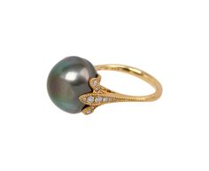 Elegant and distinctive, this Shinkai pearl ring exudes a feminine sophistication. The domed gray South Sea pearl has a stunning natural nacre. It is set in 18K yellow gold and diamond petals at the center on the slightly tapered matte 18K yellow gold band. It exudes a stunning, statement-making presence. south sea pearl : 14mm diameterdiamonds : vary : just under 1mm diameter to 2mm diameter each : .29cttw18K yellow gold band width : 1.5mm to 2.5mmsize available : 6.5please contact us for sizin Luxury Tahitian Pearl Ring In Yellow Gold, Luxury Yellow Gold Tahitian Pearl Ring, Elegant Yellow Gold Tahitian Pearl Rings, Wedding Tahitian Pearl Ring In Yellow Gold, Formal Yellow Gold Tahitian Pearl Ring, Wedding Yellow Gold Tahitian Pearl Ring, Gold Tahitian Pearl Ring Fine Jewelry, Gold Tahitian Pearl Rings For Wedding, Elegant Tahitian Pearl Wedding Ring