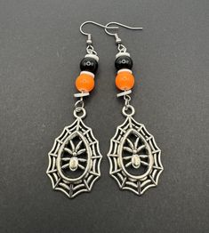 Embrace the spooky season with these Halloween dangling earrings that capture the essence of the holiday perfectly. Adorned with intricately designed spider webs and glass beads, each earring tells a whimsical tale of Halloween folklore. The lightweight yet eye-catching design ensures comfort while making a bold statement. Whether you're dressing up for a costume party or simply adding a touch of Halloween spirit to your ensemble, these earrings are the ideal accessory. Let these festive earring Spooky Adjustable Black Jewelry, Adjustable Black Spooky Jewelry, Black Spooky Jewelry For Costume Party, Gothic Dangle Halloween Jewelry, Gothic Dangle Jewelry For Halloween, Spooky Halloween Jewelry For Costume Party, Witchy Jewelry For Halloween Jewelry Making, Spooky Black Nickel-free Jewelry, Spooky Halloween Costume Party Jewelry