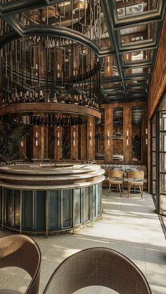 the interior of a restaurant with wooden walls and ceilinging, large circular bar area