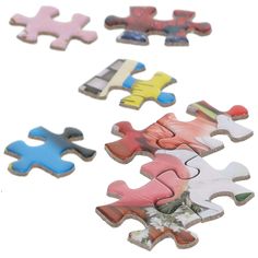 four pieces of puzzle sitting on top of each other