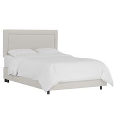 a bed with white sheets and linens on top of it, in front of a white background