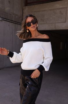 Stay stylish with our Classy Contrast Sweater. Featuring a sleek black and white contrast, an off the shoulder design, and a minimalistic look, this sweater is perfect for everyday wear. Elevate your wardrobe with this versatile piece. Fabric 60% acrylic, 40% nylon Chic Black Sweater With Ribbed Cuffs, Black Off-shoulder Sweater For Fall, Black Stretch Off-shoulder Sweater, Chic Tops With Contrast Color For Fall, Black Off-shoulder Sweater For Spring, White Off-shoulder Fall Sweater, Trendy Black Off-shoulder Sweater, Trendy Off-shoulder Black Sweater, Modern White Sweater For Fall