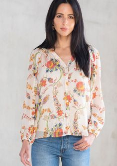 Our new spring go-to, this lightweight bohemian top is designed in a vintage-inspired floral print. With a ruffle-trimmed long sleeve, a button front, and a flattering split v-neckline. We love to style this flowy boho blouse tucked into denim. FINAL SALE Floral print Chiffon Relaxed fit Voluminous long sleeve with ruffled trim Elastic wrist cuff Hip length Split v-neckline Button front Sheer Lining included Bohemian flowy top Model is 5'10, wearing a size S.Style: I-13887WL-RTA-YC Floral Print Chiffon, Bohemian Tops, Flowy Blouse, Sheer Top, Flowy Tops, Chiffon Blouse, Boho Blouses, Beautiful Blouses, Embroidered Top