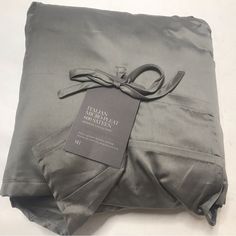 a folded gray sheet with a tag on it