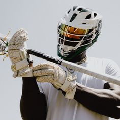 a man holding a baseball bat and glove in front of his face wearing a helmet