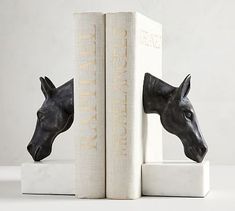 two bookends with horse heads on them