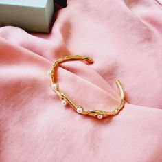 This curvy pearl bangle is a versatile minimalist piece that goes with any look. Wear it with another bracelets to create an arm party. Combine it with Miss Flirty Ring, La Koko Ring or La Sugar Ring to complete the look. It is perfect for gift giving for women and teen girls. Ideal for Valentine's Day, Mother's Day, Thanksgiving gift, Birthday, Anniversary, Christmas, Promise, Gifts, etc. Bracelet Details: Material: 18K Gold Plated & Stainless Steel Thickness: 3mm Quantity: 1 Color: Gold Does n Minimalist Metal Pearl Bracelet, Minimalist Pearl Bracelet For Gift, Minimalist Metal Pearl Bracelet For Gift, Minimalist Metal Pearl Bracelet As Gift, Trendy Pearl Bangle Bracelet Gift, Feminine Adjustable Bangle Bracelet, Adjustable Feminine Bangle Bracelet, Trendy Adjustable Metal Pearl Bracelet, Trendy Gold Bangle Pearl Bracelet