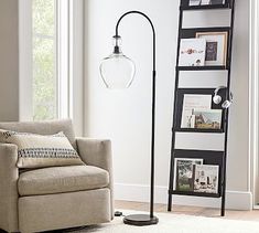 a living room with a chair, lamp and bookshelf