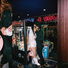 a man and woman standing in front of a vending machine