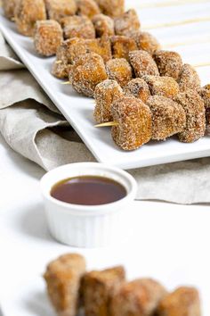 there are several desserts on the plate and one has dipping sauce in front of it