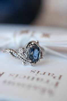 a blue ring sitting on top of an open book