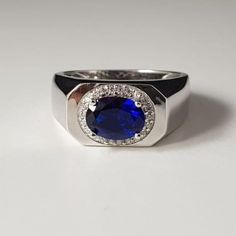 "Description -: Metal - 925 Sterling Silver Stone - ( Lab Created ) Tanzanite Shape - Oval Color - Bluish - Violet Manufacturing - India Stone Size- 7X9MM Tanzanite's deepest shade, Indigo, combines the intuition of the violet ray with the trust of the pure blue ray. It brings wisdom, truth, dignity and spiritual mastery. A stone of judgment and long life, it promotes introspection and can result in profound wisdom when used well. It was eventually named tanzanite in honor of its country of origin. The tanzanite birthstone is often described as \"velvety,\" mostly because of its deep and saturated color, which ranges from a pure rich blue to violet, with the blue considered most valuable." Formal Signet Ring With Polished Round Stone, Formal Signet Ring With Polished Finish, Modern Sapphire Signet Ring For Anniversary, Elegant Silver Sapphire Signet Ring, Formal Round Gemstone Signet Ring, Formal Sterling Silver Halo Ring, Classic 14k White Gold Sapphire Ring With Polished Finish, Silver Sapphire Diamond Ring With Hallmark, Luxury Silver Sapphire Halo Ring