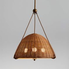 a light hanging from a ceiling fixture with wicker shades on the top and bottom