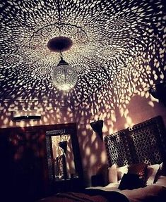 a bed room with a light that is shining on the ceiling