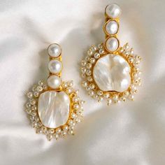 The Amelia dangle pearl earrings are the perfect statement to bring out your feminine, romantic side. Featuring 22ct gold-plated brass, freshwater baroque pearls, and acrylic pearls. Handmade by artisans in India. Limited quantity available. For pierced ears22ct gold plated brassCream baroque pearlsAcrylic pearls Size