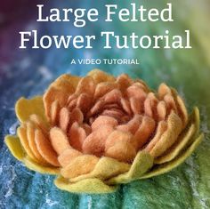 the large felted flower is shown on top of a green surface with text overlay