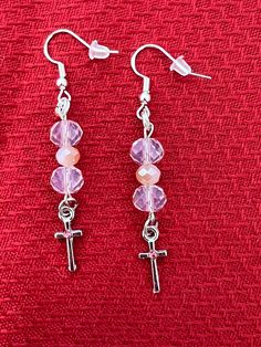 These beautiful lightweight pink/silver beaded earrings are sure to add a colorful accent to any wardrobe!   Attached are adorable crosses with a pink accent stone. All charms are nickel free.   All of my earrings are made with nickel-free, hypoallergenic ear wires.  The earring backs are made of clear silicone. The hooks themselves are 925 sterling silver.   Earrings are approximately 2" in length from the top of the ear wires to the bottom of the earring rings.  All of my earrings are pretty a Nickel-free Pink Beaded Earrings, Pink Hypoallergenic Beaded Earrings With Round Beads, Pink Hypoallergenic Beaded Drop Earrings, Pink Hypoallergenic Adjustable Beaded Earrings, Adjustable Hypoallergenic Pink Beaded Earrings, Nickel Free Pink Dangle Beaded Earrings, Nickel Free Pink Round Bead Earrings, Nickel-free Pink Dangle Beaded Earrings, Nickel Free Adjustable Cross Earrings