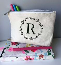 Thank your guests with a beautiful canvas zipper pouch, personalised with their initials!Made from ivory heavyweight canvas and lined this zipper bag is a versatile item that's great for use as a make up bag, storage bag or pencil case. Each bag is personalised on the front with a monogrammed laurel wreath. The design is available in a variety of colours, see the last image for the choices available.Size: 8 x 5.5 x 1.5 inches ** Spot clean only. Please note that these zipped pouches are made fro Cricut Canvas Pouch, Canvas Cosmetic Pouch As Gift, Canvas Pouch Cosmetic Bag For Gift, Monogram Canvas Pouch Bag, Canvas Zipper Pouch Cricut, Canvas Zipper Pouch Vinyl, Personalized Rectangular Bag With Zipper Pouch, Personalized White Zipper Pouch Cosmetic Bag, Pencil Case Pattern