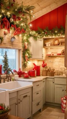 a kitchen decorated for christmas with red and green decorations