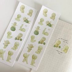 two sheets of stickers with different animals on them, one is green and the other is white