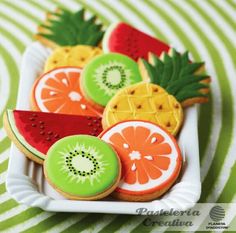 some cut up fruit cookies on a white plate with green and orange stripes in the background