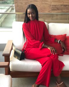 a woman sitting on top of a white couch