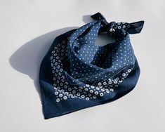 a blue bandana with white polka dots on it