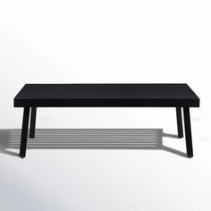 a black coffee table sitting on top of a white floor