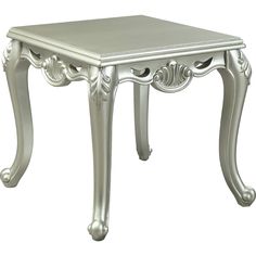 a white table with an ornate design on the top and bottom, sitting against a white background