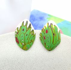 "* These one of a kind  abstract green studs are very lightweight and comfortable to wear.  * The nickel free steel closure is securely fixed in the base of the earrings, that makes it durable. ➣ SIZE: Lenght:   3,5 cm (1.38') Width:   2,5 cm (0.98') Weight of each earring: 4 g  PLEASE check the size carefully. The earrings may appear larger on the photos. ➣ORDER & DELIVERY: Earrings are ready to ship. They're packed in a cute small box and an envelope/cardboard to arrive safely. ➣GIFT WRAPPING: Is your purchase a gift? I'll wrap your gift nicely, add a handwritten tag/card with your text (optional). Just select a \"Gift wrapping\" during the checkout. ➣MATERIAL: Polymer clay, Hypoallergenic nickel free steel. ➣CARE RECOMMENDATIONS: Polymer clay is a long-lasting material. To enjoy your je Whimsical Green Hand Painted Earrings, Green Hand-painted Polymer Clay Jewelry, Green Hand Painted Polymer Clay Jewelry, Hand Painted Green Polymer Clay Jewelry, Hand Painted Green Earrings In Polymer Clay, Green Hand-painted Polymer Clay Earrings, Green Hand Painted Polymer Clay Earrings, Hand Painted Green Polymer Clay Earrings, Green Hand Painted Artistic Earrings