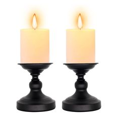 two black candles with one lit and the other turned off