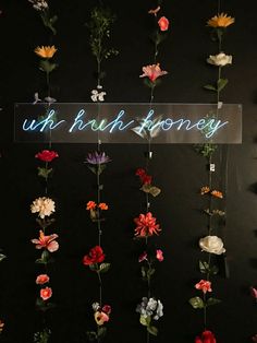 a bunch of flowers that are hanging on a wall with the words uk british honey