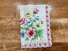 "An beautiful vintage floral handkerchief. It has a white, sheer base with white, blue and green flowers all over, and yellow, green, blue, and pink flowers in the corner. It also has white, scalloped trimming on the edges. Perfect for using as a quilt square for a quilt. It measures 14 1/2\" by 14 1/2\". It is in great vintage condition with no rips, tears or holes. Unused. Please come visit our shop to view our entire vintage selection at GoosesTreasureShop- https://www.etsy.com/shop/GoosesTre White Handkerchiefs As Spring Gifts, White Handkerchiefs For Spring Gifts, Spring Gift White Handkerchiefs, Vintage Flower Shaped Handkerchiefs For Spring, Vintage Flower-shaped Handkerchiefs For Spring, Vintage Flower Handkerchiefs For Spring, Spring Vintage Flower Shaped Handkerchiefs, White Flower-shaped Handkerchiefs For Spring, Vintage Handkerchiefs For Spring Gift