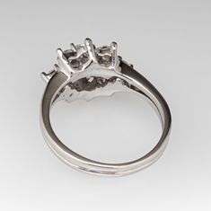 This beautiful ring is centered with one (1) round brilliant cut diamond set into a six- prong setting. The center stone is bordered with eight (8) round brilliant cut diamonds set into three-prong settings. The ring measures 10.6mm at the top, rises 7.2mm above the finger, tapering to 2.4mm wide and 0.8mm thick at the base of the shank. It is currently a size 5.75. Fine Jewelry Platinum Cluster Ring With Prong Setting, Classic Round Halo Ring With Prong Setting, Timeless Round Cluster Ring With Prong Setting, Platinum Cluster Ring With Prong Setting, Fine Jewelry, Platinum Cluster Ring With Prong Setting, Platinum Cluster Ring With Round Cut Prong Setting, Halo Ring With Prong Setting For Promise, Round Cut, Halo Promise Ring With Prong Setting And Round Cut, 14k White Gold Cluster Ring With Prong Setting