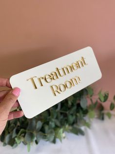 someone holding up a sign that says treatment room