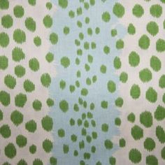 a green and white background with dots on it