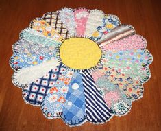 a wooden table topped with lots of different pieces of cloth