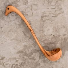 a wooden spoon shaped like an animal's tail