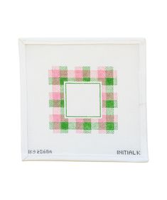 a cross stitch picture frame with pink, green and white checkered squares on it