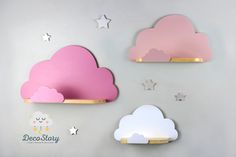 two pink and white clouds are on the wall next to each other, with stars above them