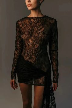 a woman in a black dress with sheer lace