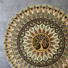 an artistically designed plate with a tree on the center in gold and brown colors