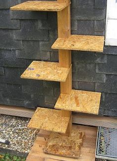 a tall wooden shelf sitting next to a brick wall