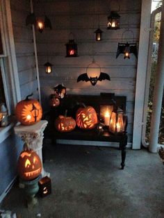 some pumpkins are lit up on the porch for halloween time and they look like bats