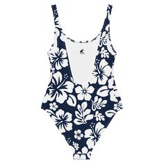 Live your best beach life in our White Hawaiian Flowers on Navy Blue One-Piece Swimsuit. With a beautiful floral print and flattering fit, this swimsuit is perfect for all shapes and sizes. The silky smooth material will have you feeling the Aloha love while you chill at the beach or pool. Now that's something to be Extremely Stoked about!• 82% Polyester, 18% Spandex• Chlorine-resistant fabric• Cheeky fit with a scoop neckline and a low scoop back• Zig-zag stitching• Double-layer front• Four-way Summer Tropical Print Swimwear For Sunbathing, Tropical One-piece Swimwear For Beach Season, One-piece Swimwear With Tropical Print For Summer, One-piece Tropical Print Swimwear For Summer, Fitted Floral Print Tankini For Sunbathing, Casual Beach One-piece With Lined Body, Fitted Floral Print One-piece Swimwear, Fitted One-piece Floral Swimwear, Tropical One-piece Swimwear For Sunbathing